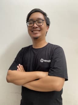 Fajar Maulana Firdaus smiling, wearing glasses and a dark shirt